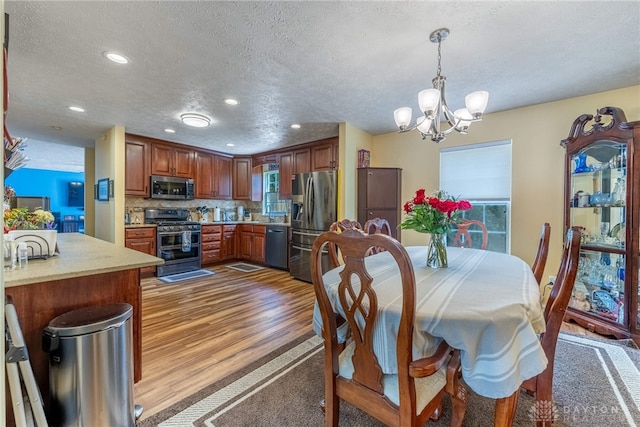 274 Tamarack Trl, Springboro, OH 45066 - dining space featuring a textured ceiling, a chandelier, wood finished floors, and recessed lighting