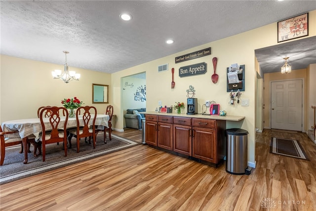274 Tamarack Trl, Springboro, OH 45066 - dining area featuring a textured ceiling, light wood-style flooring, a chandelier, and recessed lighting