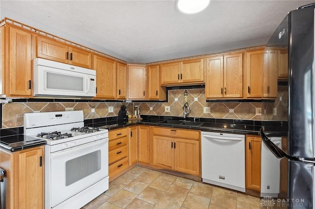 1220 Bookwalter Ave, New Carlisle, OH 45344 - kitchen with white appliances, dark countertops, decorative backsplash, a textured ceiling, and light stone finish flooring
