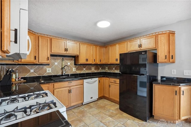 1220 Bookwalter Ave, New Carlisle, OH 45344 - kitchen featuring freestanding refrigerator, white dishwasher, range, backsplash, and light stone finish floors