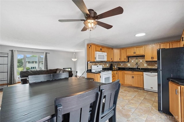 1220 Bookwalter Ave, New Carlisle, OH 45344 - kitchen with white appliances, dark countertops, ceiling fan, backsplash, and open floor plan