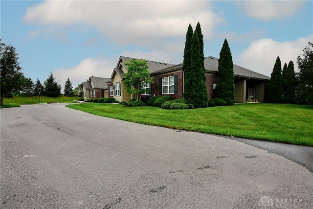 6963 Gentry Ln, Mason, OH 45040 - view of property exterior with a yard and brick siding