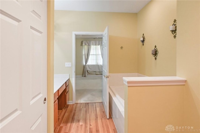 6963 Gentry Ln, Mason, OH 45040 - full bathroom featuring vanity, wood finished floors, and a garden tub