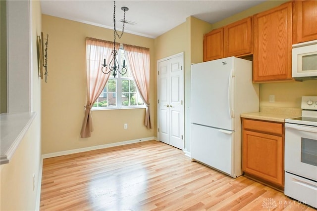 6963 Gentry Ln, Mason, OH 45040 - kitchen featuring white appliances, light wood-type flooring, light countertops, decorative light fixtures, and brown cabinetry