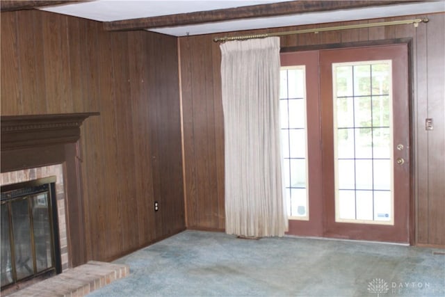 461 Poplar Grove Dr, Vandalia, OH 45377 - unfurnished living room featuring wood walls, a fireplace, carpet flooring, and beam ceiling