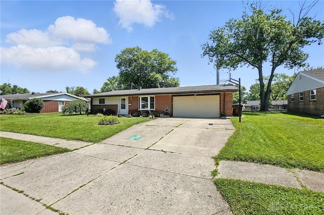407 Overla Blvd, Englewood, OH 45322 - single story home featuring driveway, a garage, brick siding, and a front lawn