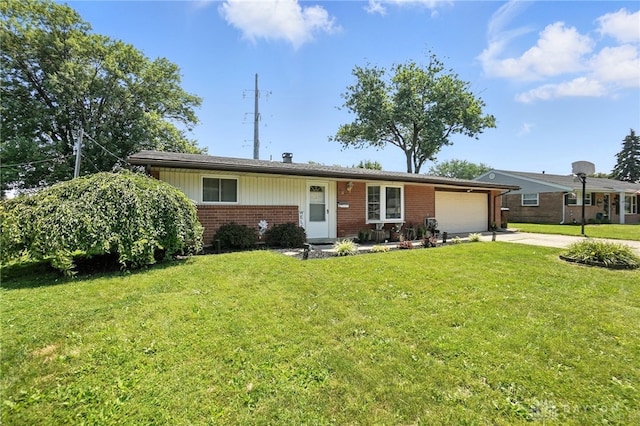 407 Overla Blvd, Englewood, OH 45322 - single story home featuring brick siding, an attached garage, concrete driveway, and a front yard