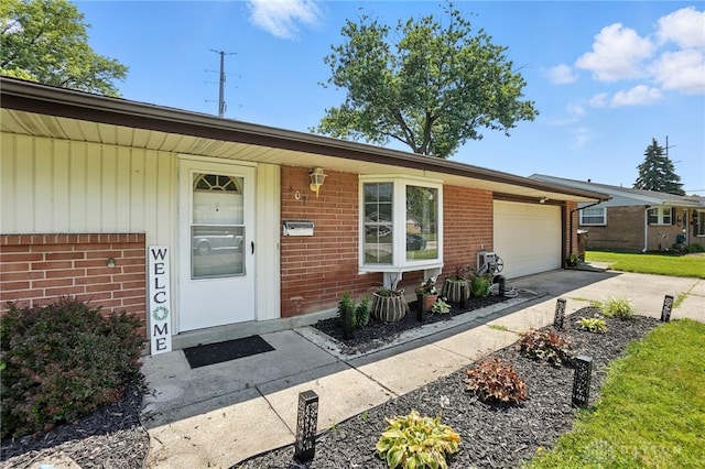 407 Overla Blvd, Englewood, OH 45322 - view of front of home with brick siding, an attached garage, and concrete driveway