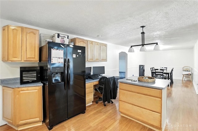 407 Overla Blvd, Englewood, OH 45322 - kitchen featuring black refrigerator with ice dispenser, light brown cabinets, a center island, light wood finished floors, and a textured ceiling