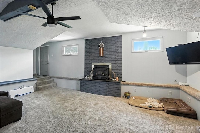 407 Overla Blvd, Englewood, OH 45322 - carpeted living area featuring a textured ceiling, healthy amount of natural light, a fireplace, and a ceiling fan