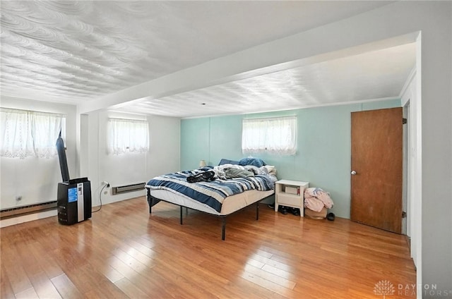 407 Overla Blvd, Englewood, OH 45322 - bedroom featuring multiple windows, hardwood / wood-style flooring, and a baseboard radiator