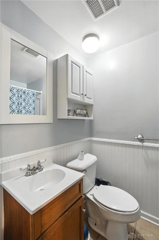 407 Overla Blvd, Englewood, OH 45322 - bathroom featuring vanity, a wainscoted wall, wood walls, and curtained shower