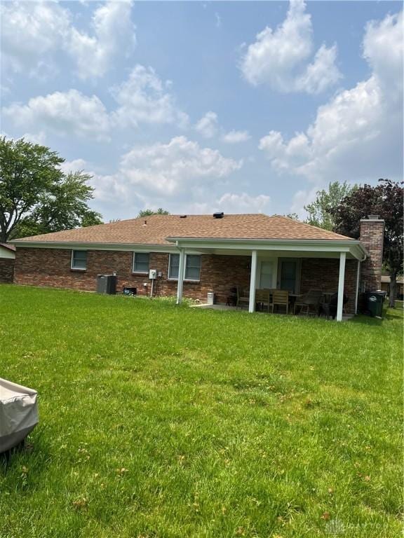4220 Pleasanton Rd, Englewood, OH 45322 - back of property with a lawn and a chimney