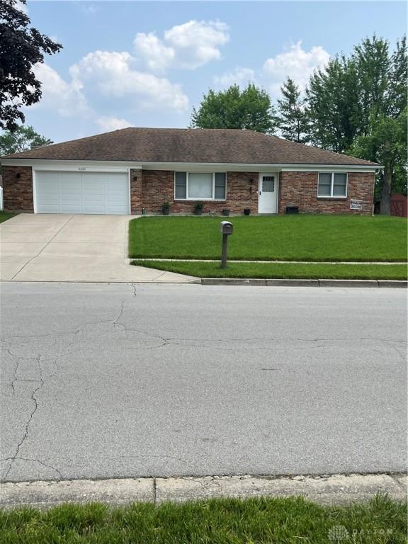 4220 Pleasanton Rd, Englewood, OH 45322 - ranch-style home with concrete driveway, a front yard, and a garage