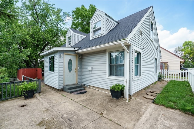 3521 E 4th St, Dayton, OH 45403 - cape cod-style house featuring entry steps, roof with shingles, and a patio area