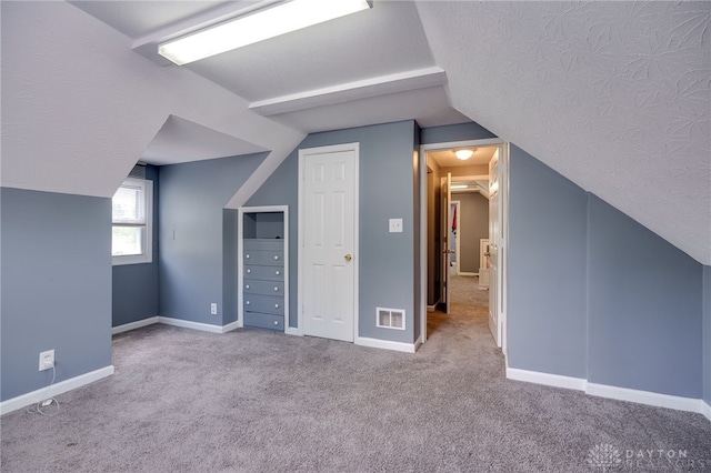 3521 E 4th St, Dayton, OH 45403 - additional living space featuring lofted ceiling, carpet floors, and a textured ceiling