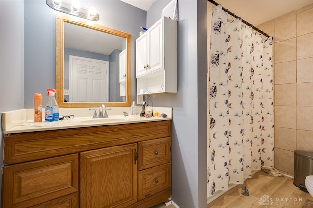 3521 E 4th St, Dayton, OH 45403 - full bath with vanity, wood finished floors, and curtained shower