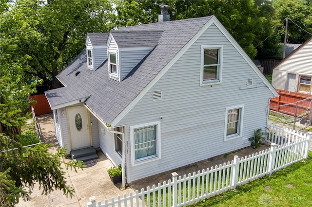 3521 E 4th St, Dayton, OH 45403 - view of front of house featuring roof with shingles, a chimney, and entry steps