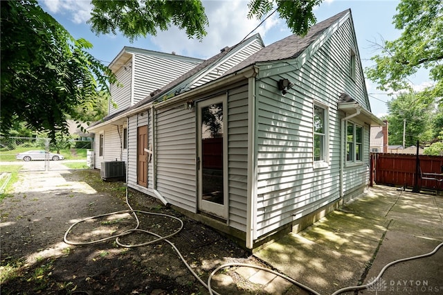 3521 E 4th St, Dayton, OH 45403 - view of side of home with a central air condition unit and a shingled roof