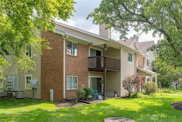 6600 Green Branch Dr Unit 5, Dayton, OH 45459 - back of property with a balcony, a yard, a chimney, and brick siding
