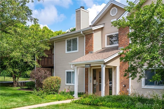6600 Green Branch Dr Unit 5, Dayton, OH 45459 - back of house featuring a chimney, a yard, brick siding, and a shingled roof