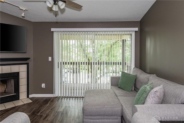 6600 Green Branch Dr Unit 5, Dayton, OH 45459 - living area featuring a ceiling fan, wood finished floors, a fireplace, and a textured ceiling