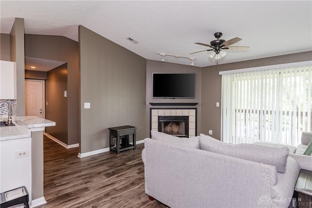 6600 Green Branch Dr Unit 5, Dayton, OH 45459 - living area featuring ceiling fan, lofted ceiling, dark wood-style flooring, a tile fireplace, and rail lighting
