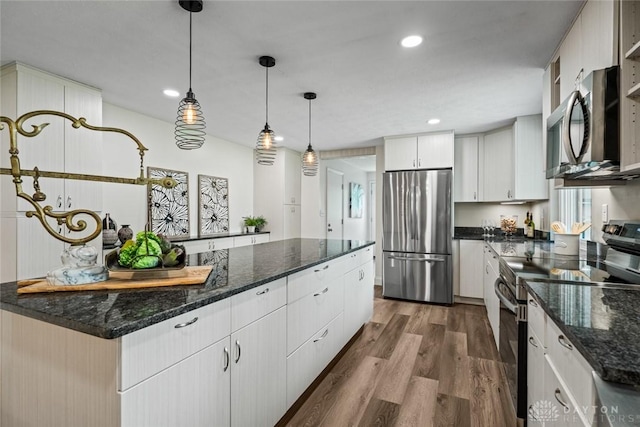 1695 Winterstone Ct, Washington Twp, OH 45458 - kitchen with appliances with stainless steel finishes, dark wood finished floors, a center island, recessed lighting, and hanging light fixtures