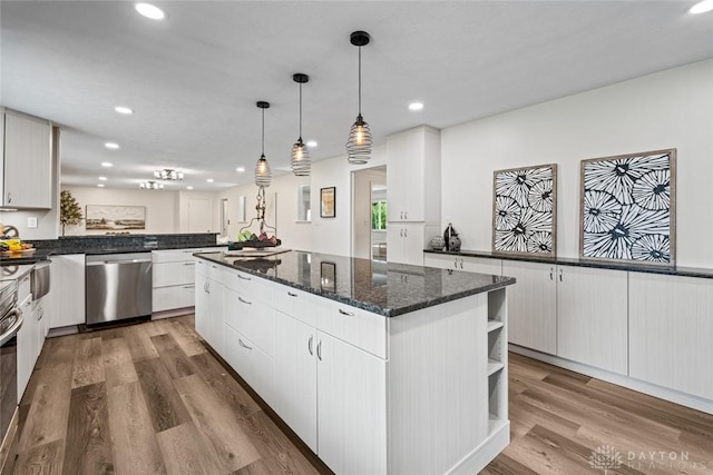 1695 Winterstone Ct, Washington Twp, OH 45458 - kitchen with dishwasher, a center island, open shelves, wood finished floors, and recessed lighting