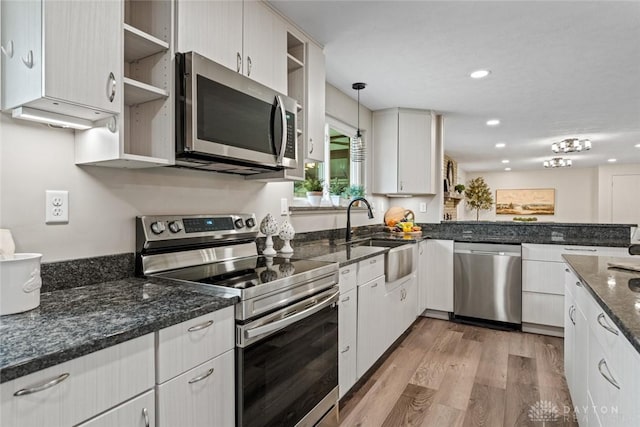 1695 Winterstone Ct, Washington Twp, OH 45458 - kitchen with appliances with stainless steel finishes, light wood-type flooring, recessed lighting, hanging light fixtures, and white cabinetry
