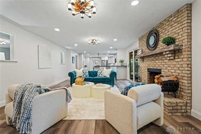 1695 Winterstone Ct, Washington Twp, OH 45458 - living area with recessed lighting, wood finished floors, a chandelier, and a brick fireplace