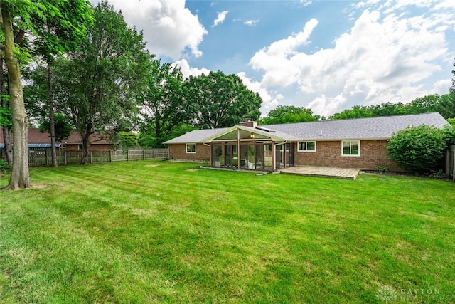 1695 Winterstone Ct, Washington Twp, OH 45458 - back of property with a fenced backyard, brick siding, a chimney, a sunroom, and a wooden deck
