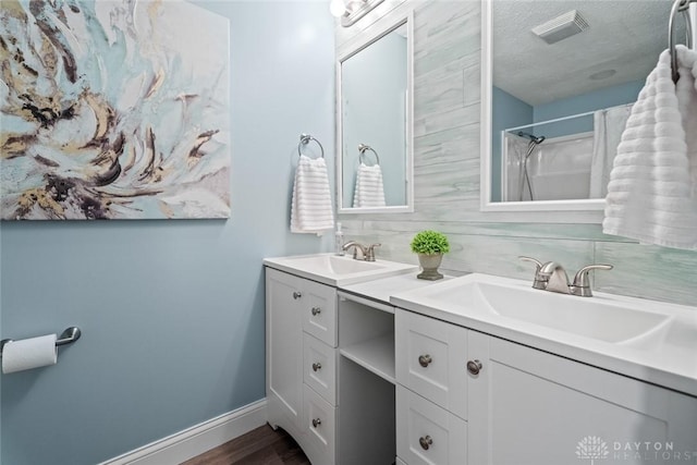 1695 Winterstone Ct, Washington Twp, OH 45458 - bathroom with vanity, wood finished floors, a textured ceiling, and a shower with shower curtain