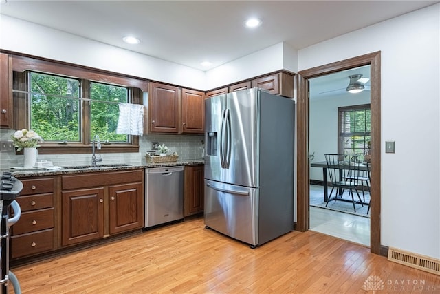1908 Court Donegal, Middletown, OH 45042 - kitchen featuring stainless steel appliances, dark stone counters, light wood-style flooring, backsplash, and recessed lighting