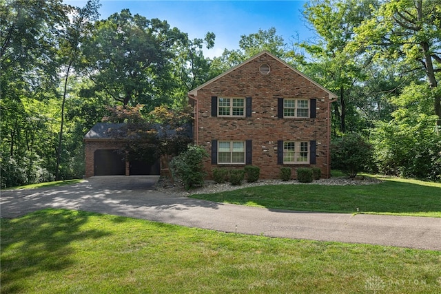 1908 Court Donegal, Middletown, OH 45042 - view of front facade featuring driveway, a garage, brick siding, and a front lawn