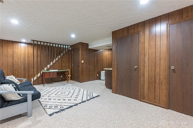 1908 Court Donegal, Middletown, OH 45042 - sitting room featuring carpet floors, wood walls, stairs, a textured ceiling, and recessed lighting