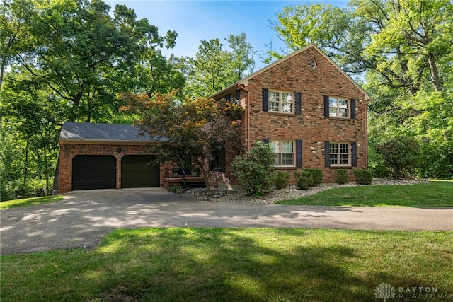 1908 Court Donegal, Middletown, OH 45042 - view of front of house with driveway, brick siding, a front yard, and a garage