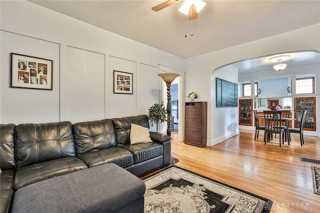 15 Harrison St, Middletown, OH 45042 - living room featuring arched walkways, light wood-style floors, and a ceiling fan