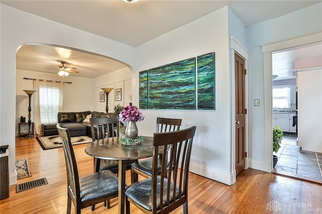 15 Harrison St, Middletown, OH 45042 - dining area with arched walkways, ceiling fan, and light wood-type flooring
