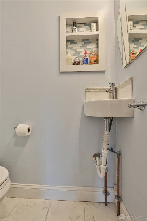 15 Harrison St, Middletown, OH 45042 - half bath featuring marble look tiles and toilet