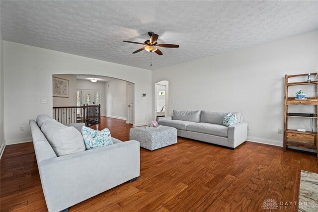 2073 Lincolnshire Dr, Beavercreek, OH 45434 - living area with arched walkways, ceiling fan, wood finished floors, and a textured ceiling