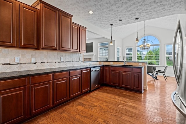2073 Lincolnshire Dr, Beavercreek, OH 45434 - kitchen featuring stainless steel appliances, healthy amount of natural light, dark wood-style flooring, lofted ceiling, and hanging light fixtures