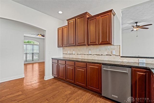 2073 Lincolnshire Dr, Beavercreek, OH 45434 - kitchen featuring dishwasher, a ceiling fan, wood finished floors, decorative backsplash, and a textured ceiling
