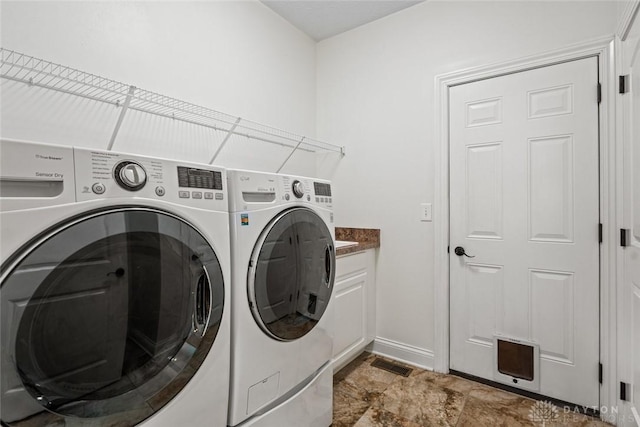 2073 Lincolnshire Dr, Beavercreek, OH 45434 - laundry room featuring independent washer and dryer and cabinet space