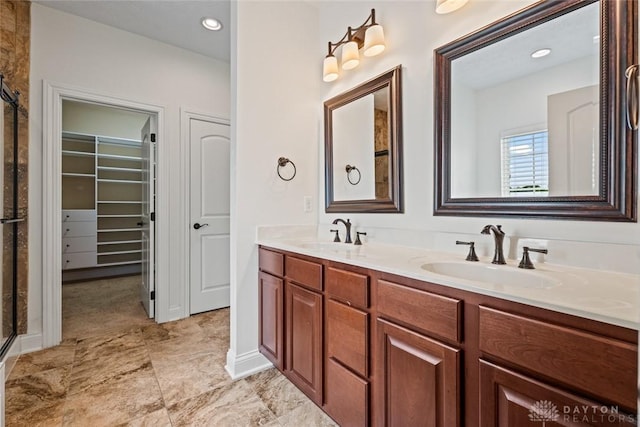 2073 Lincolnshire Dr, Beavercreek, OH 45434 - bathroom with a stall shower, double vanity, a spacious closet, and recessed lighting