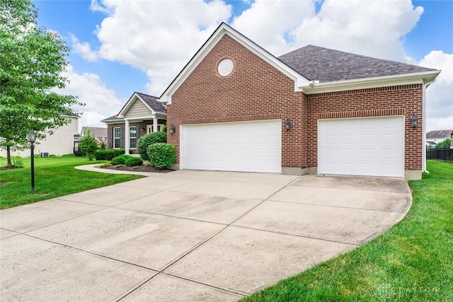 2073 Lincolnshire Dr, Beavercreek, OH 45434 - view of front of property with an attached garage, a front yard, driveway, brick siding, and roof with shingles