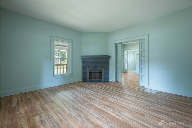 19 Mckinley St, Middletown, OH 45042 - unfurnished living room featuring light wood-type flooring and a brick fireplace