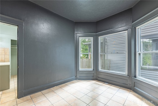 19 Mckinley St, Middletown, OH 45042 - spare room featuring light tile patterned floors, a textured wall, and a textured ceiling