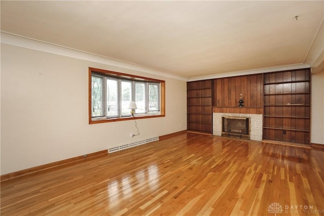 702 W Sharon Rd, Forest Park, OH 45240 - unfurnished living room with light wood-style floors, ornamental molding, and a fireplace