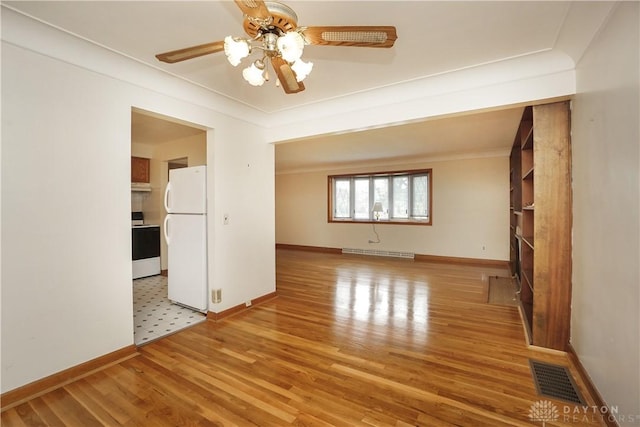 702 W Sharon Rd, Forest Park, OH 45240 - unfurnished living room with a ceiling fan, light wood finished floors, and ornamental molding